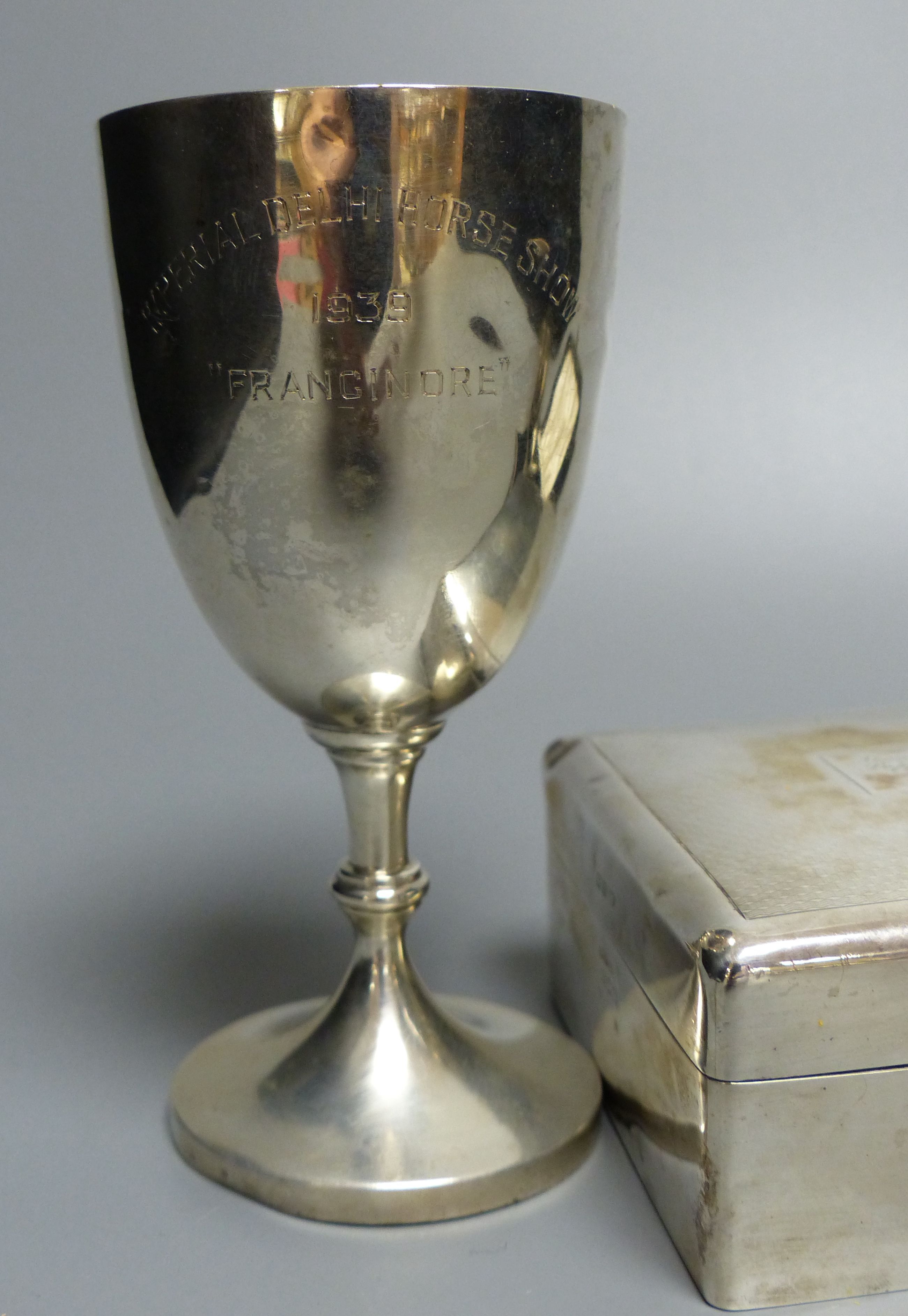 A sterling goblet, silver cigarette box, small beaker and cased spoon & pusher.